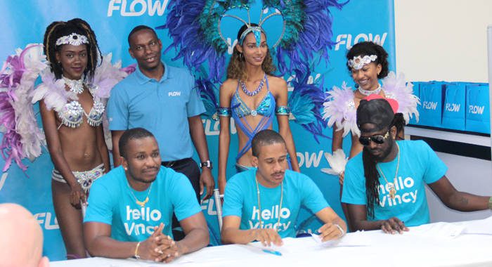 Flow brand ambassadors Hyper4000, Rodney Small and Skinny Fabulous pose with the company's country manager, Wayne Hull, and models after signing a contract at Friday's launch. (IWN photo)