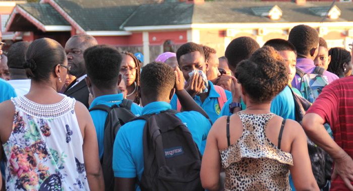 Members of the Grammar School Young Leaders group cry at the Grenadines Wharf on Saturday. (IWN photo)
