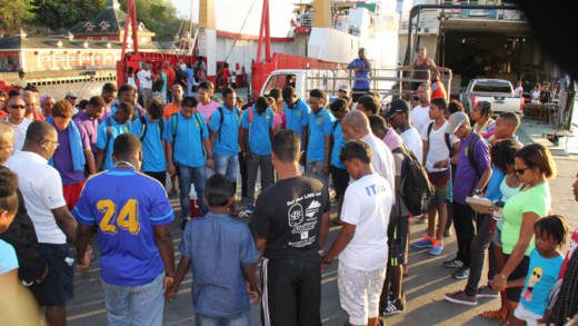 The Young Leader along with relatives, friends, education officials, and counsellors at the Grenadines Wharf after their return to Kingstown Saturday afternoon. (IWN Photo)
