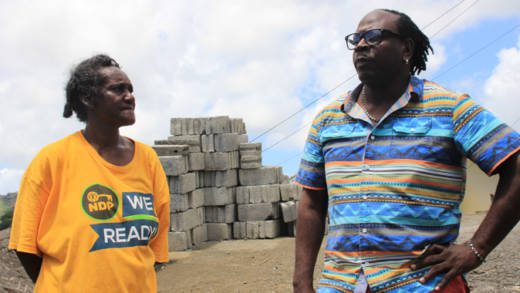 Brother of Pastor Nigel Morgan, soca artiste James Jamesy P Morgan speaks with Janice Caesar, mother of burn victim, Cuthbert Mafia Victory in Marriaqua on Thursday. (IWN photo) 