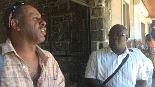 Terry Bynoe and Duane Lewis of the Canouan Island Development Council chat in Kingstown on Monday after their meeting with government officials.  (IWN photo) 