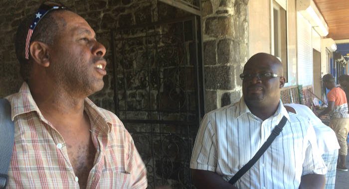 Terry Bynoe and Duane Lewis of the Canouan Island Development Council chat in Kingstown on Monday after their meeting with government officials.  (IWN photo) 