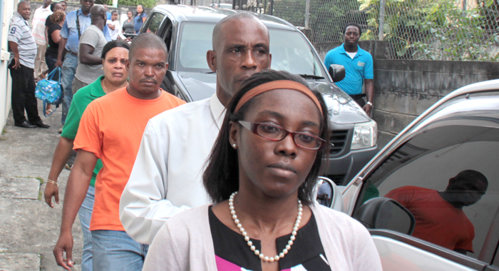 Crystal Morgan, front right, her father, Pastor Nigel Morgan and police officers arrive at the Serious Offences Court in Kingstown on Friday. (IWN photo)