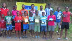 Some of the recipients of football shoes, along with parents and members of the Kenville Horne Sports Academy. Horne is furthers right. 