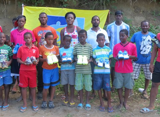 Some of the recipients of football shoes, along with parents and members of the Kenville Horne Sports Academy. Horne is furthers right. 