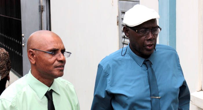 School principal Colbert Bowens, left, was Wednesday freed of a charge in connection with the death of seven students. He chats with Pastor Ehud Myers, who is still before court on the same matter.  (IWN photo)