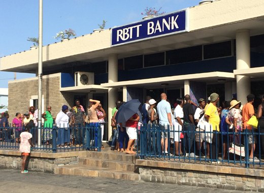 Long lines formed outside RBTT after the News newspaper reported on May 13, 2016 that depositors would be charged EC$25 a month to keep their savings at the banks. A number of reporters who were at the bank on May 18, was given a telephone number for Nicole Duke-Westfield, RBC Financials senior manager of corporate communications, based in Trinidad. But the person who answered our call to Duke-Westfield said she was unavailable to take the call, and instructed us to leave a voicemail message for her. (IWN photo)