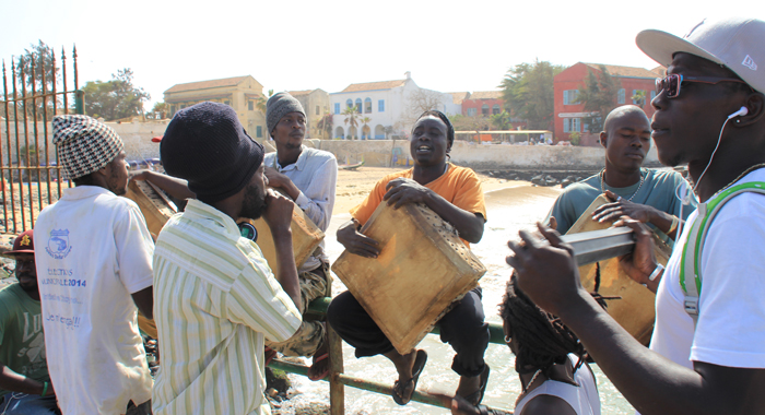 Musicians beat drums and play other traditional instruments to welcome visitors to Gorée Island. (IWN photo)