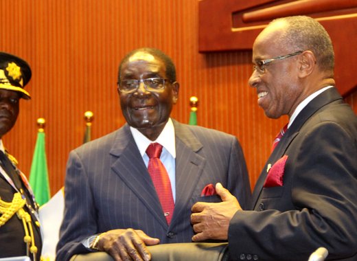 Deputy Prime Minister of St. Vincent and the Grenadines, Sir Louis Straker, right, chats with President of Zimbabwe, Robert Mugabe at the ACP summit in Papua New Guinea. (Photo: ACP/Josephine Latu-Sanft)