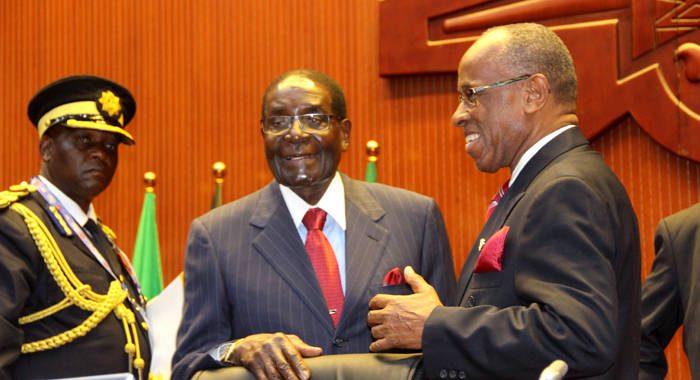 Deputy Prime Minister of St. Vincent and the Grenadines, Sir Louis Straker, right, chats with President of Zimbabwe, Robert Mugabe at the ACP summit in Papua New Guinea. (Photo: ACP/Josephine Latu-Sanft)