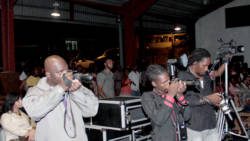 Journalist Ashford Peters, left, and other media workers at Friday's show. Peters was made to pay to enter the venue. (IWN photo)
