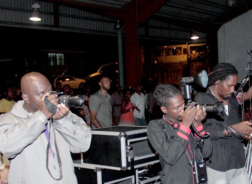 Journalist Ashford Peters, left, and other media workers at Friday's show. Peters was made to pay to enter the venue. (IWN photo)