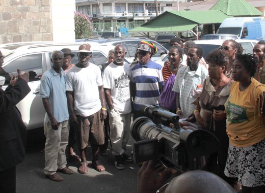 Leader of the opposition Arnhim Eustace speaks with party supporters outside the courthouse after Thursday's hearing. (IWN photo)