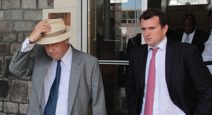 Queen’s Counsel Justin Fenwick and a colleague leave the court building in Kingstown on Wednesday. (IWN photo)