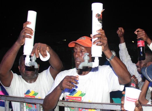 Calypso patrons show off their "rum pipes" at the semis at Victoria Park on Friday. (IWN photo)