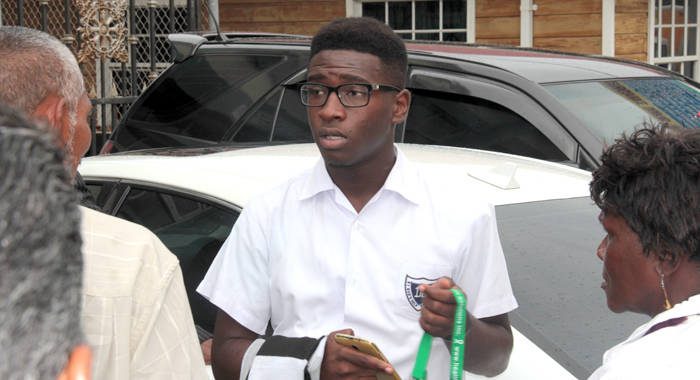 NDP youth activist youth activist, Shabazaah GunMunro George wore his school uniform to court on Monday. (IWN photo)