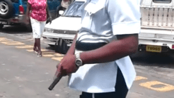 A police officer drew his gun as two students fought in Kingstown on Friday.