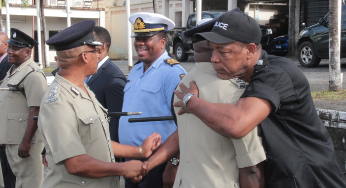 Head of the Rapid Response Unit, ASP Timothy Hazelwood embraces Charles at the end of Thursday's parade. (IWN photo)