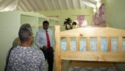 Digicel Country Manager, John Gidharry, leads a tour of the refurbished home. (IWN photo)