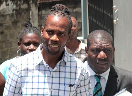 Calypsonian Paul "I-Madd" Scrubb, left, and his lawyer, Israel Bruce in July. (IWN photo)