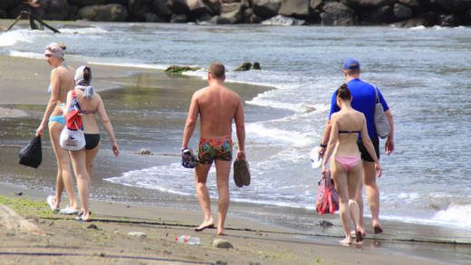 Visitors to SVG walk along the beach in Buccament Bay in April 2016. (iWN photo)