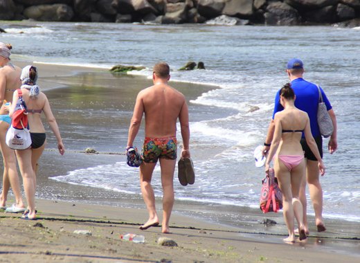 Visitors to SVG walk along the beach in Buccament Bay in April 2016. (iWN photo)