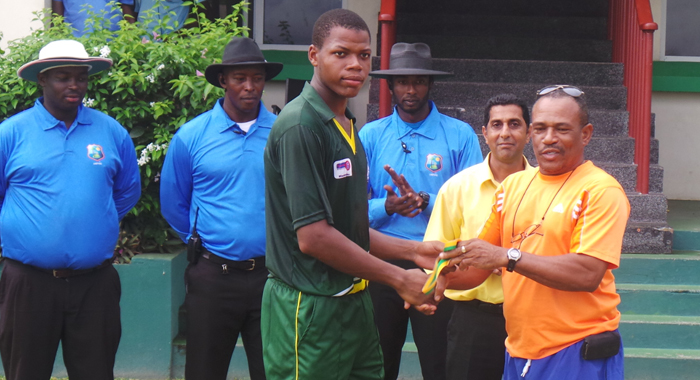 Anil Mathews collects his man of the match prize from Samuel Holder, General Secretary of SVG Cricket Association. 