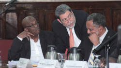 Prime Minister Dr. Ralph Gonsalves, centre, speaks with Opposition Leader Arnhim Eustace, left, and VP of the NDP, Dr. Godwin Friday, during the debate of the Cybercrime Bill on Thursday. (IWN photo)