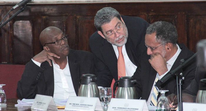 Prime Minister Dr. Ralph Gonsalves, centre, speaks with Opposition Leader Arnhim Eustace, left, and VP of the NDP, Dr. Godwin Friday, during the debate of the Cybercrime Bill on Thursday. (IWN photo)