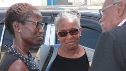 Luzette King, centre, in conversation with her lawyers, Shirlan "Zita" Barnwell, left, and Bayliss Frederick. (IWN photo)