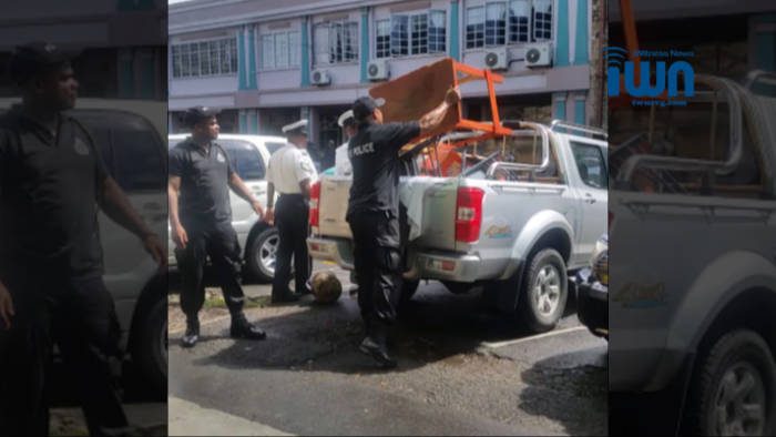 Police remove protester's possessions from the "Front Line" in Kingstown on Friday.  