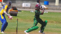 Windwards captain Emmanuel Stewart sweeps during his innings of 54. 