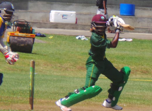 Windwards captain Emmanuel Stewart sweeps during his innings of 54. 