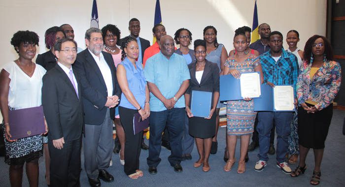 Scholarship recipients pose with Ambassador Ger, 2nd left, PM Gonsalves, third left, Minister of Education Jimmy Prince, 5th left, and La Toya Williams, furthest right, who will teach English in Taiwan. (IWN photo) 