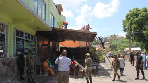 Chill Spot workers look on from the rooftop as state officials demolish part of the restaurant on Sept. 21. (IWN photo)