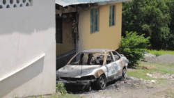 Jafari Robertson's burnt out car outside his home in Prospect. (IWN photo)