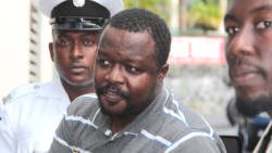 Former cop Kimolow Quashie, centre, as he arrived in court in September 2016. (IWN photo)