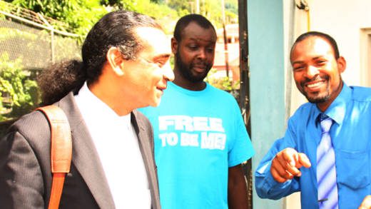 Police Constable Orthwel "O.B." John, right poses, his lawyer, Ronnie Marks, left, and witness Chris Walsh outside the court after the not-guilty verdict. (IWN photo)