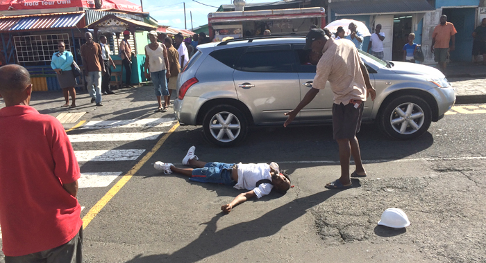 Pedestrians react after the man was knocked unconscious. (IWN photo)