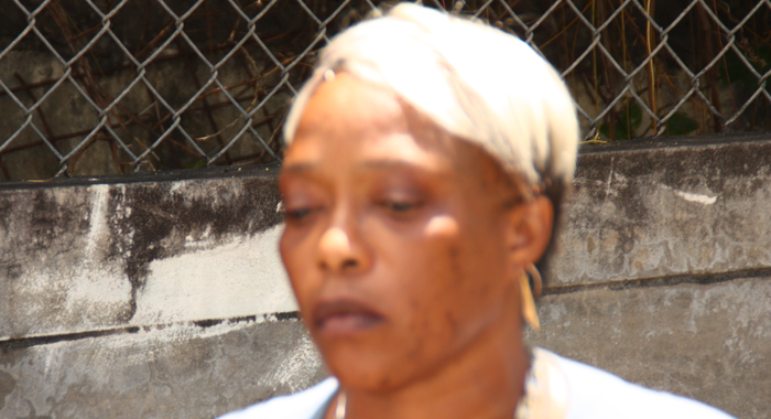 The convicted man's mother contemplates his fate outside the courthouse. (IWN photo)