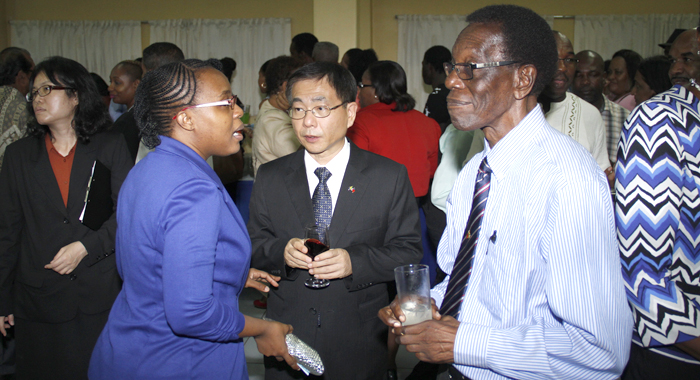 Alpian Allen, left, who was Minister of Foreign Affairs under the NDP from 1994 to 1998, chats with Ambassador Ger, centre, and Anesia Baptiste of the Democratic Republican Party at Tuesday's event. (IWN photo)