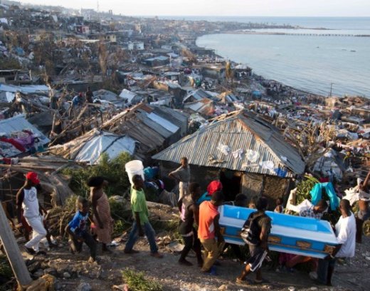 In Jeremie, Haiti, Hurricane Matthew claimed the life of a pregnant woman, whose remains were carried in a coffin by local residents on Friday, October 7, 2016. (CNN photo)