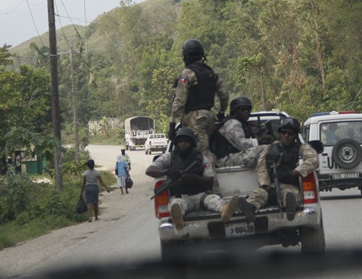 Haitian police officers prevent other vehicles from overtaking a UN convoy on the way to southern Haiti earlier this month. (CMC photo)