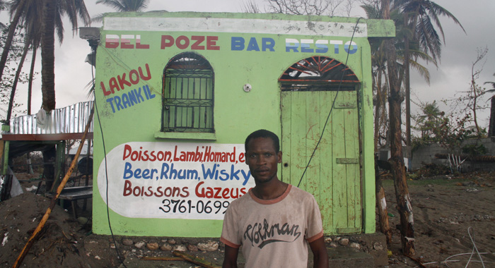 Lejier Eval stands outside of what used to be his restaurant along the seashore in Geléein southern Haiti. (Photo: CMC/IWN)
