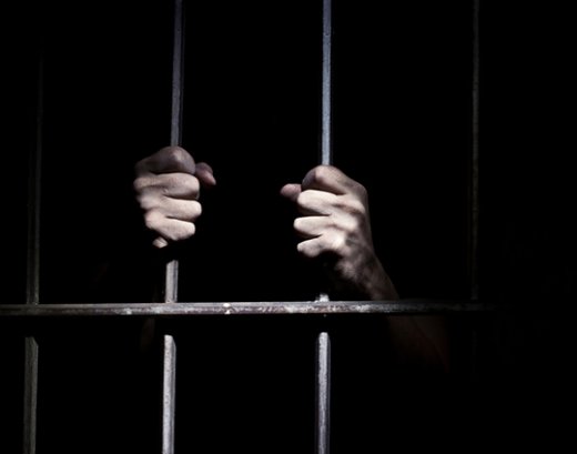 hands on prison bars