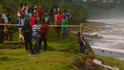 Police and onlookers at the scene in Colonairie last month. (Photo: Rochelle Baptiste/Facebook)