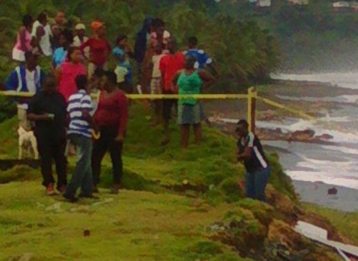 Police and onlookers at the scene in Colonairie last month. (Photo: Rochelle Baptiste/Facebook)