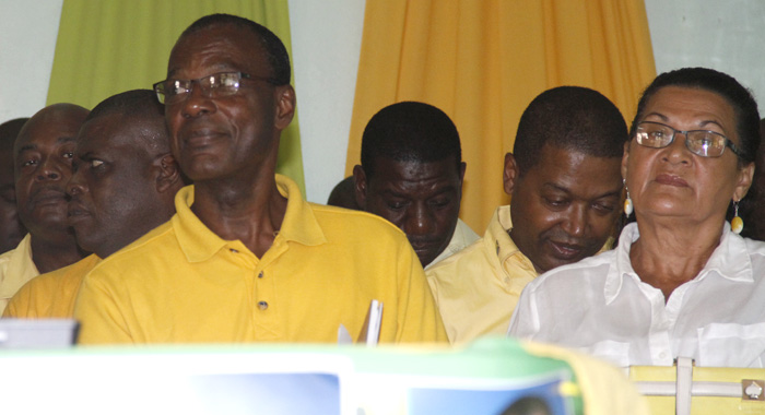 MP for West Kingstown, Daniel Cummings, left, listens to the speech by Lewis (not seen) at Sunday's convention. (IWN photo)