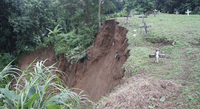 The landslide washed some graves into the river and exposed the contents of others. (IWN photo)