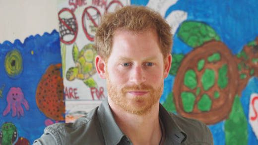 Prince Harry stands in front of pieces of art produced by student competitors in the Ministry of Fisheries essay and art competition under the theme "No Extinction In Our Generation. Save Our Sea Turtles" in Colonairie on Saturday. (Photo: Ovid Burke/IWN)
